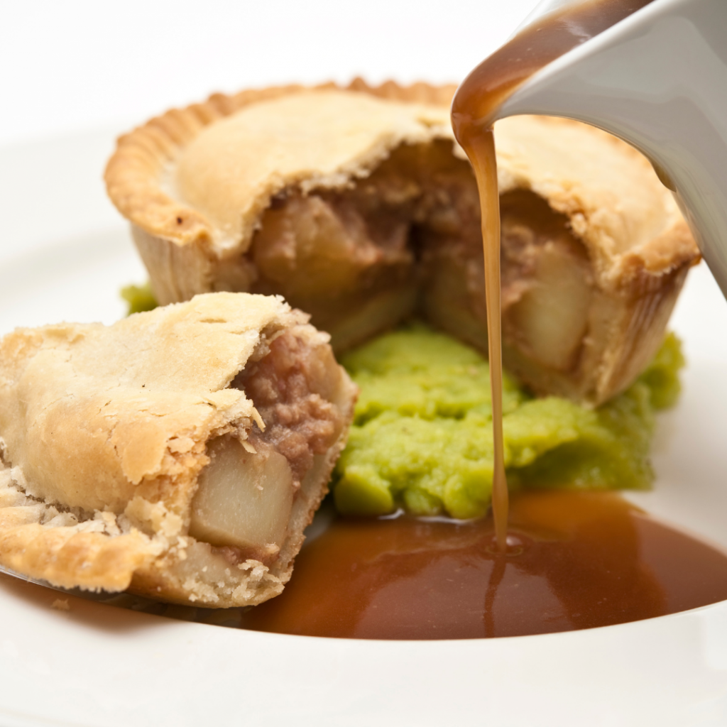 Quirky feast: Meat pie, mushy peas, and mash drenched in gravy cascade, plate poised for devouring.